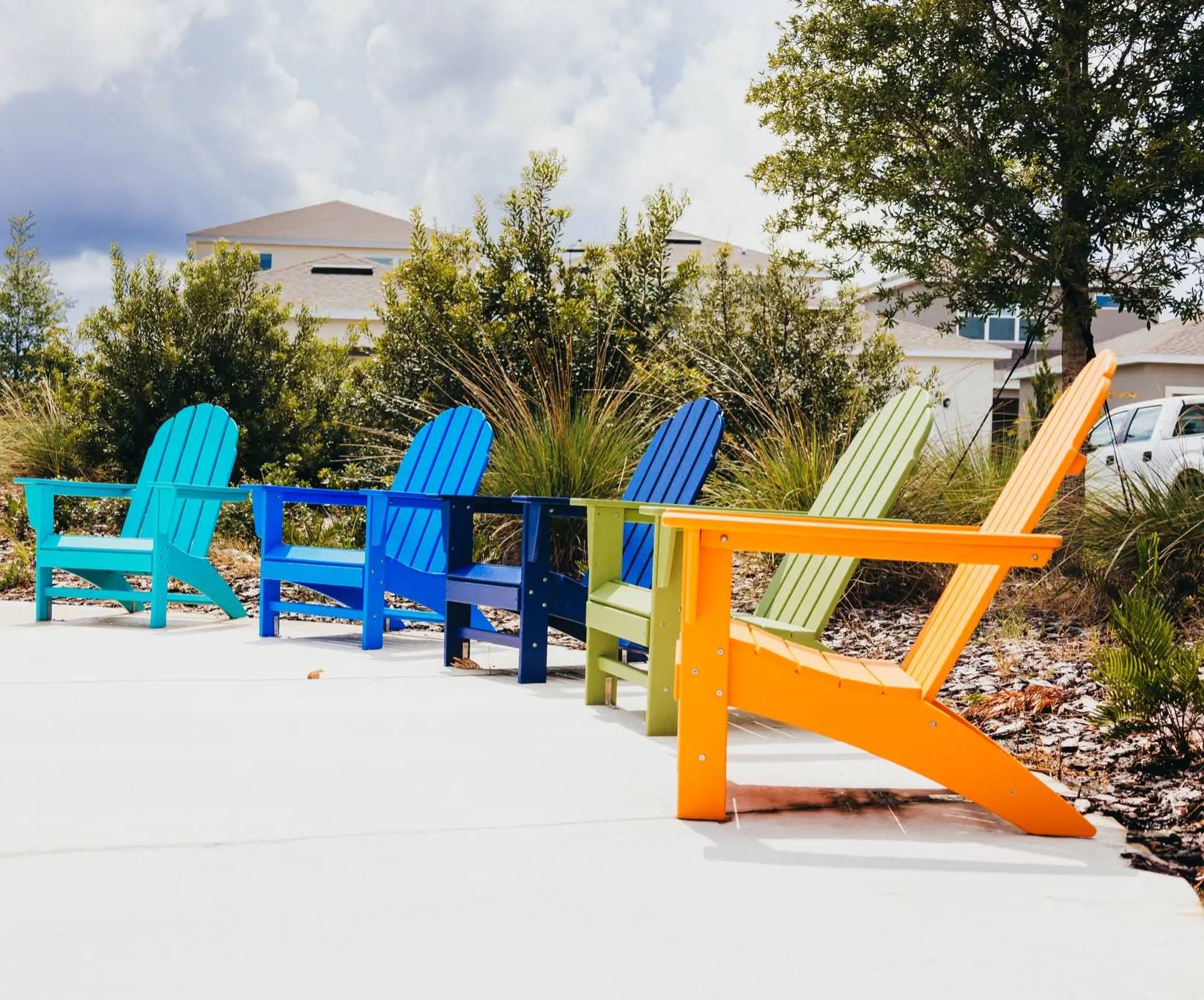 Vibrant lawn chairs under cloudy sky