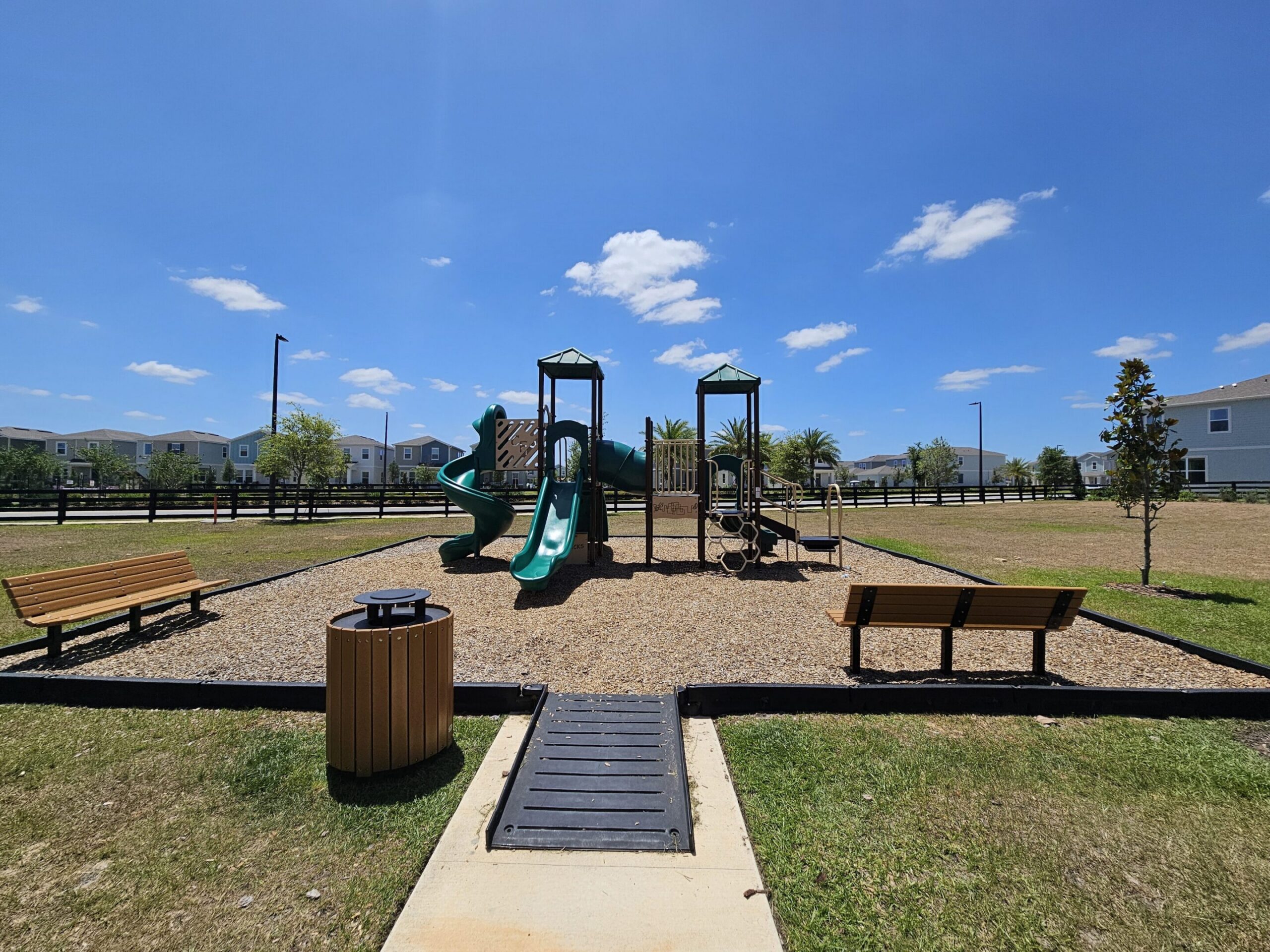 Park playground with benches and slides
