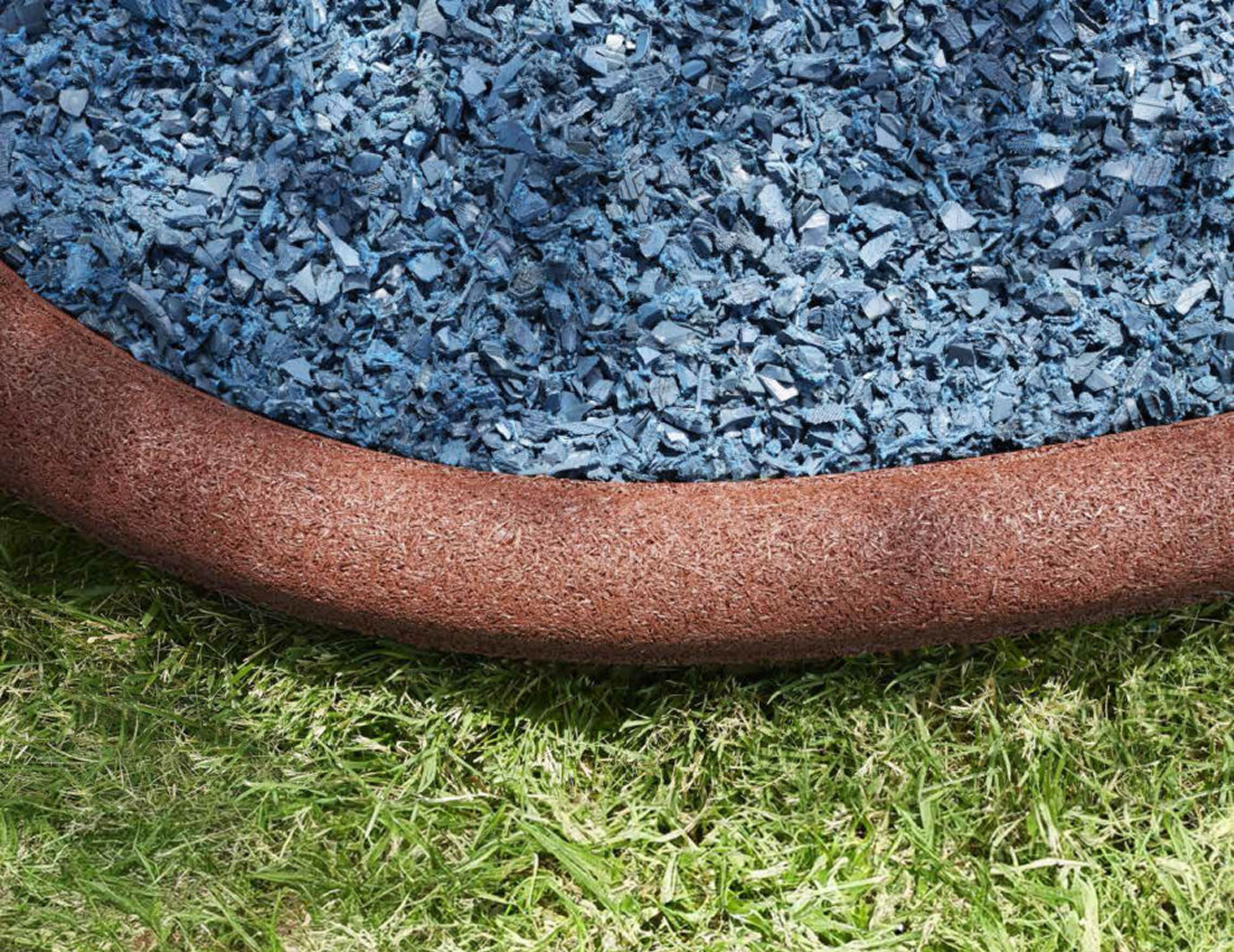Blue rubber mulch and green grass