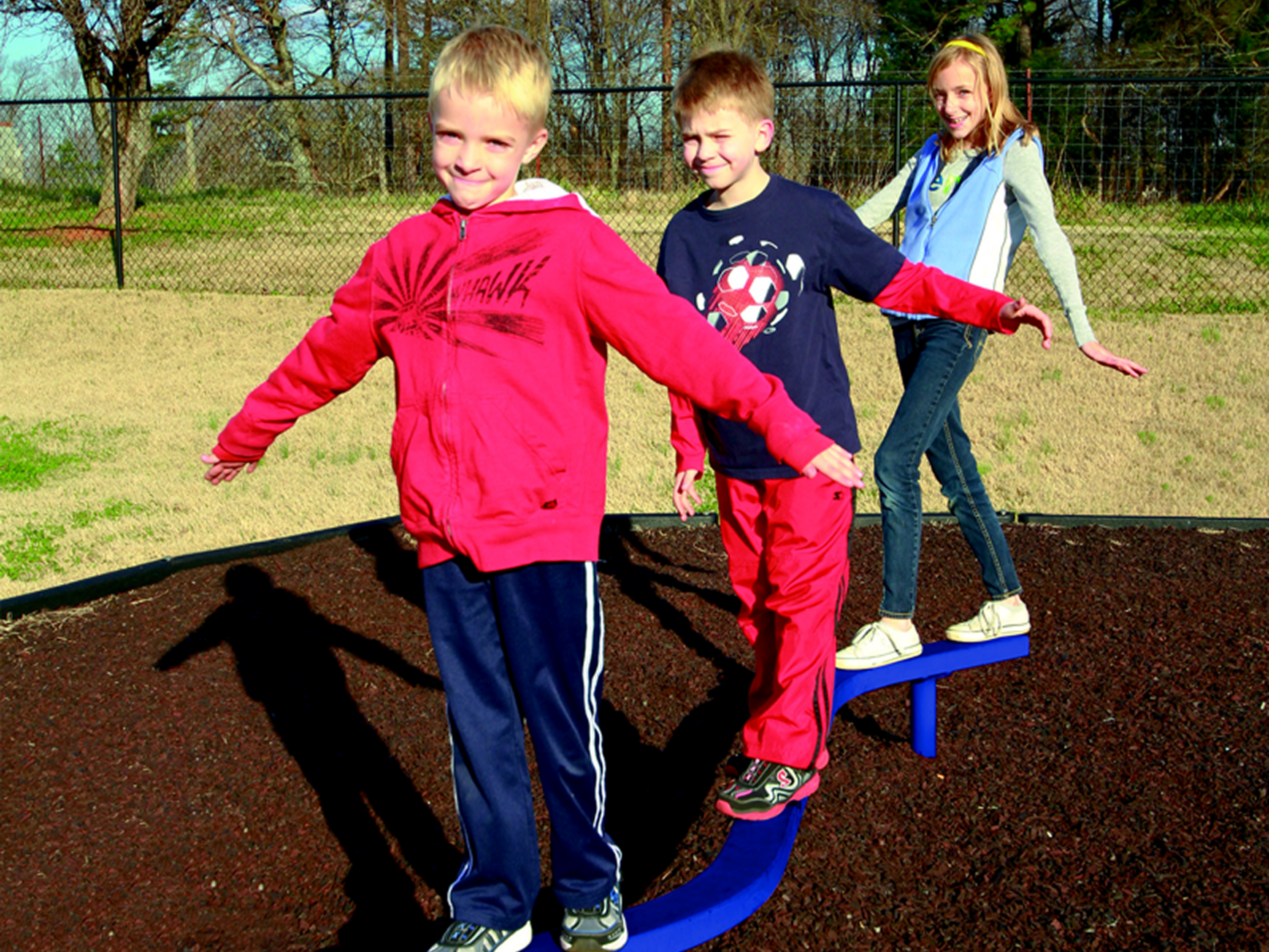 Kids playing on seesaw outdoors