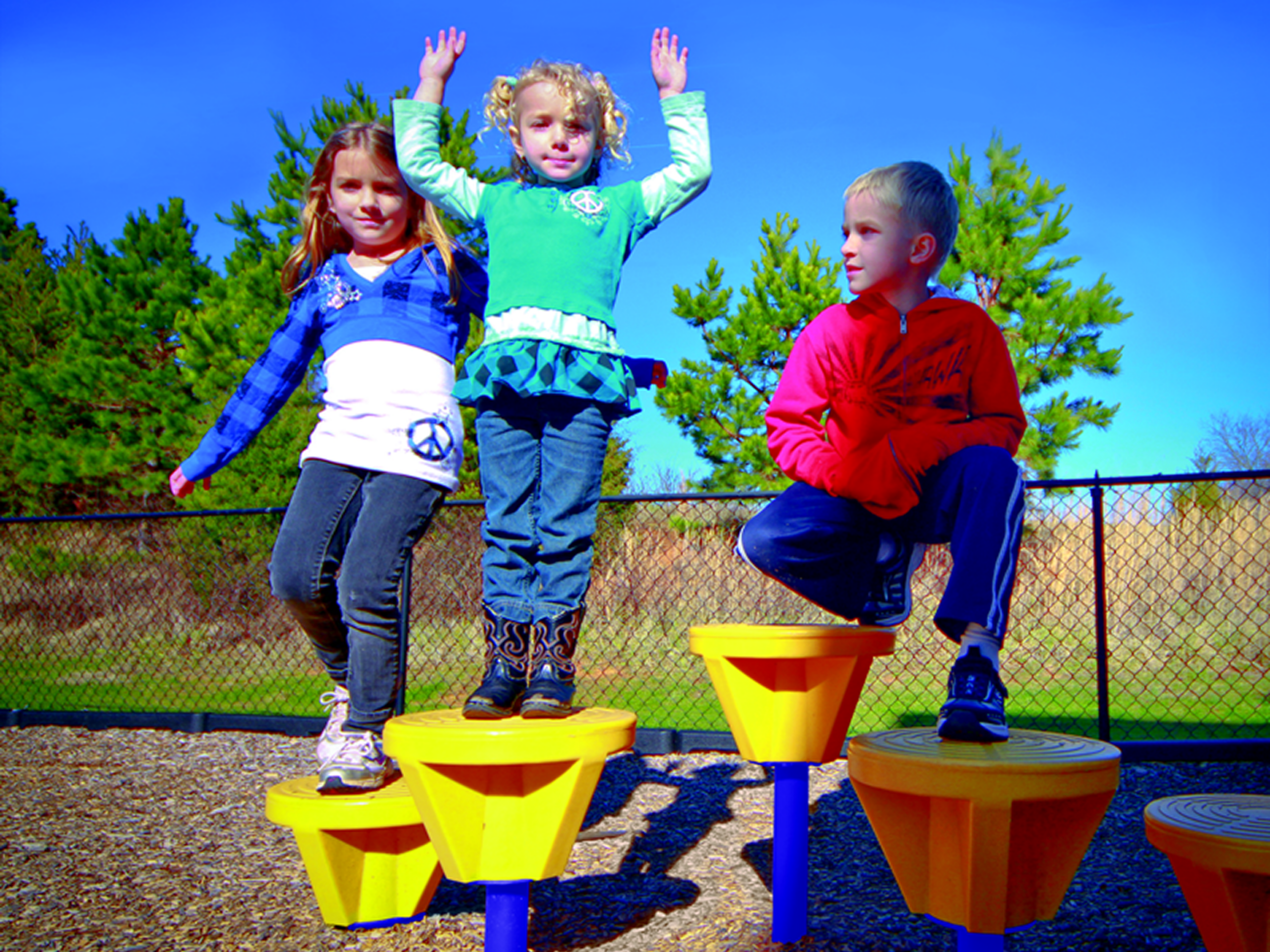 Kids balancing on playground stepping stools