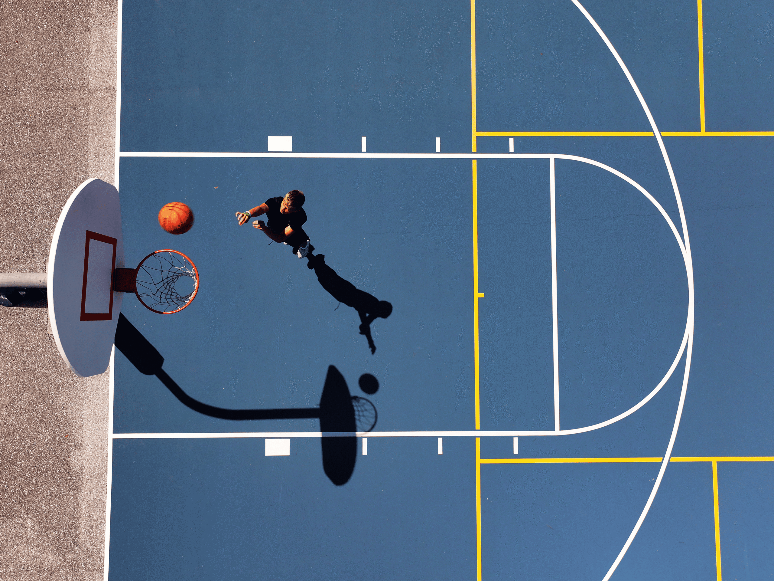 Shadow of player on basketball court