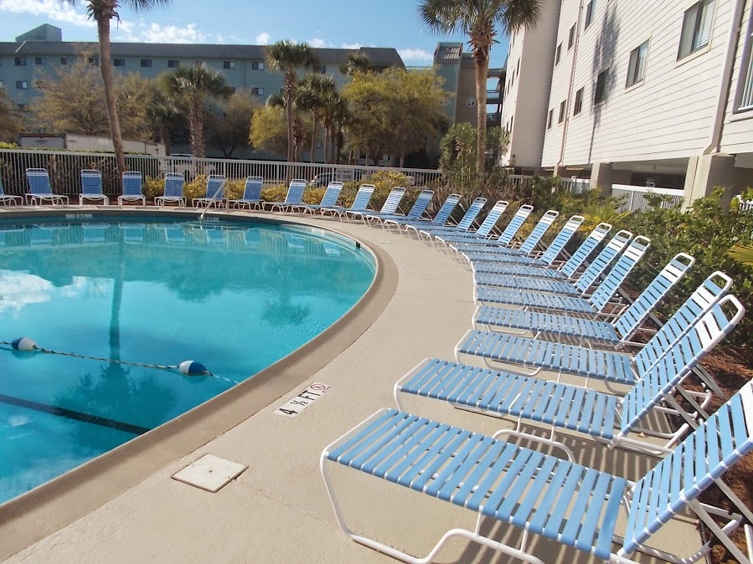 Relaxing pool area with blue chairs