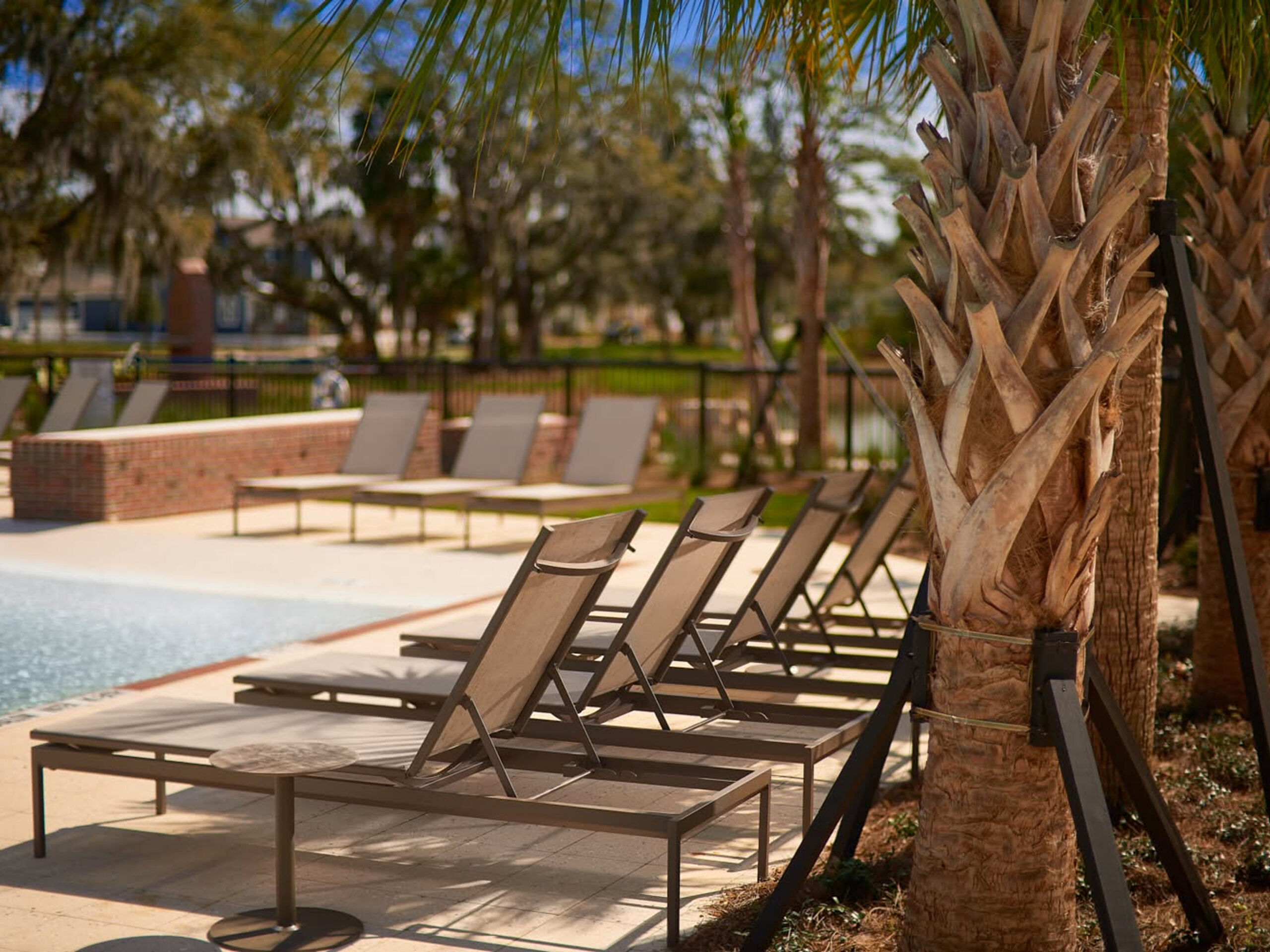 Relaxing poolside with empty lounge chairs