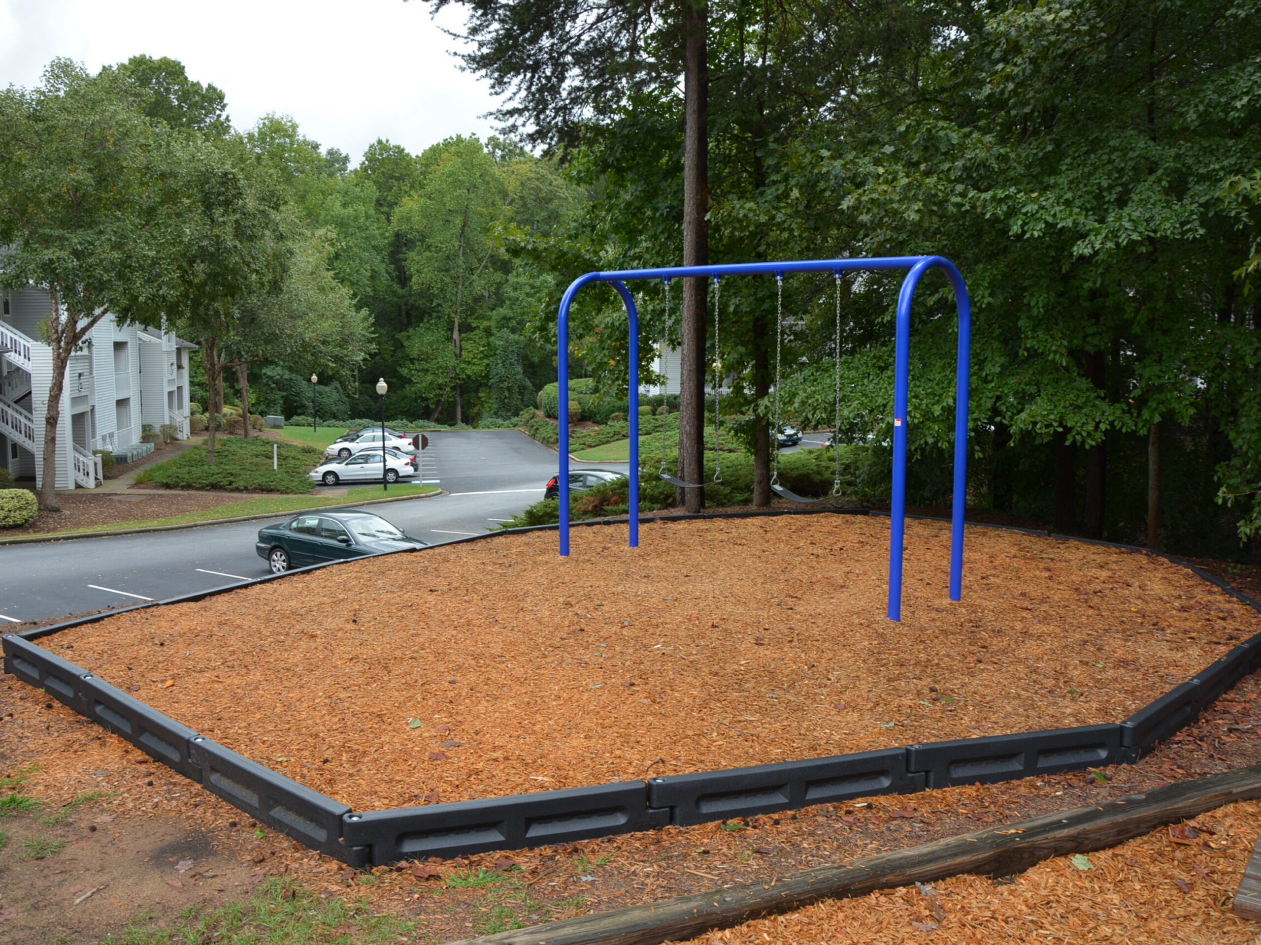Playground swing set with wood chip base