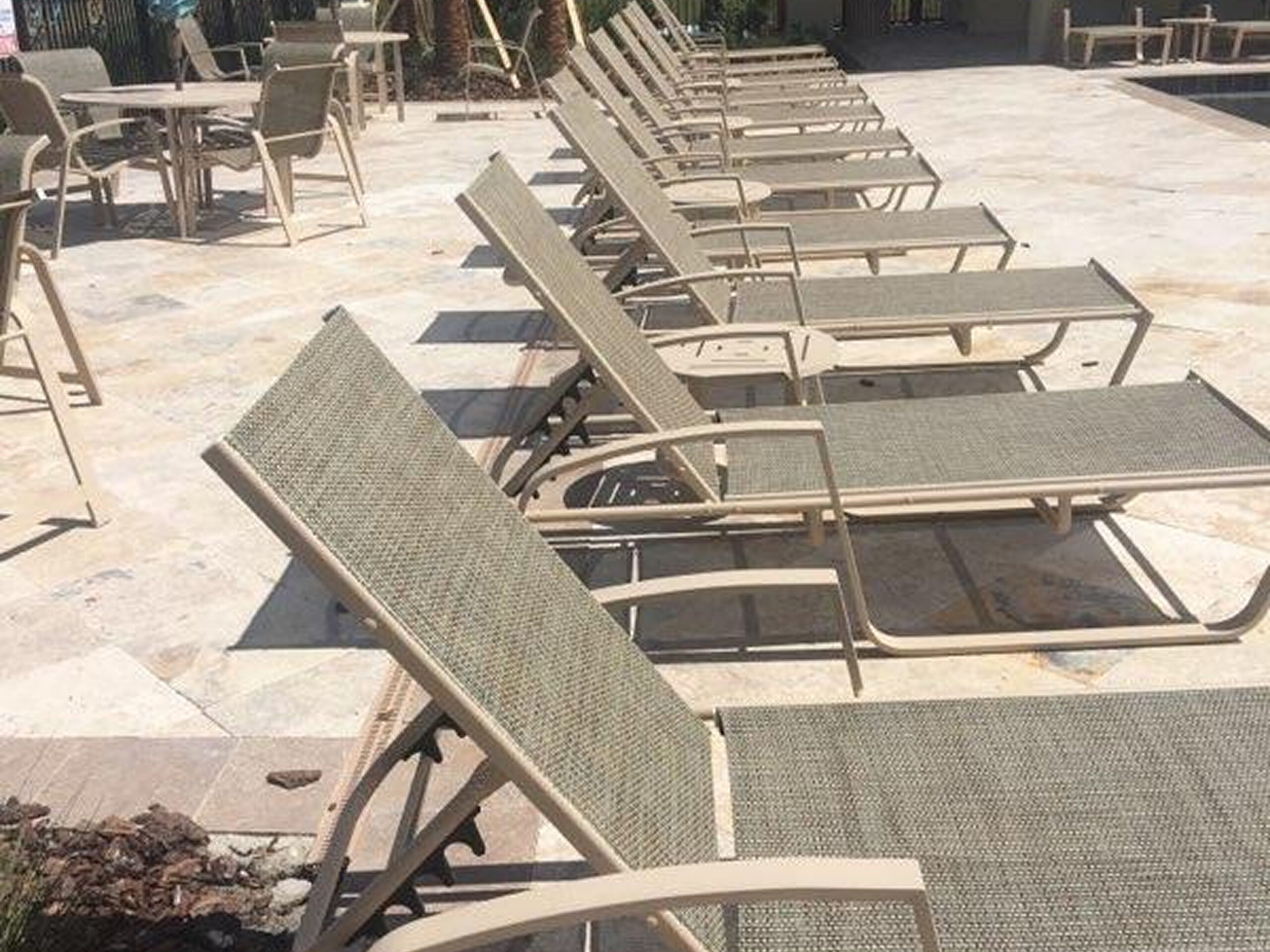 Row of sun loungers by poolside