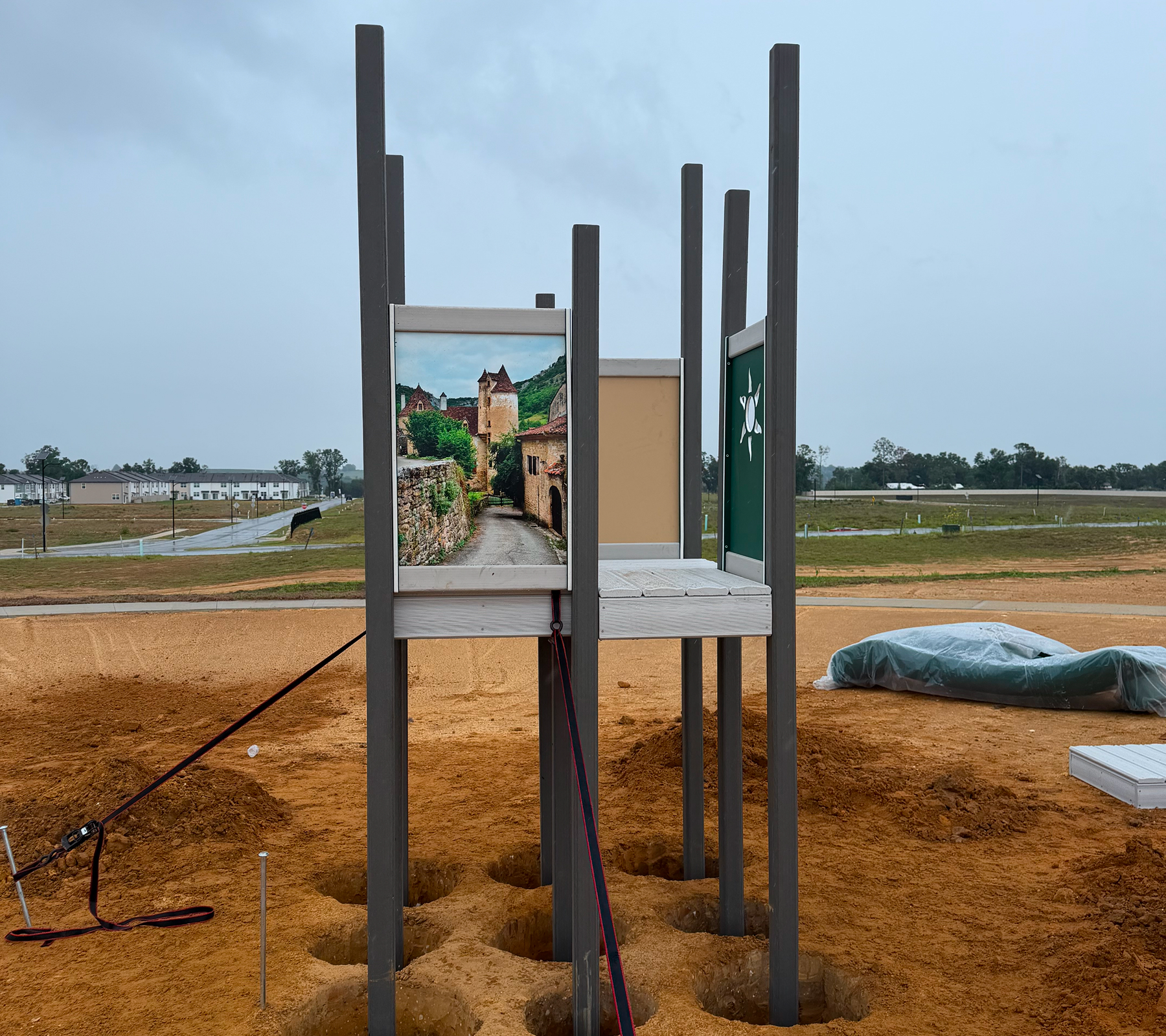 Unfinished play structure on dirt ground