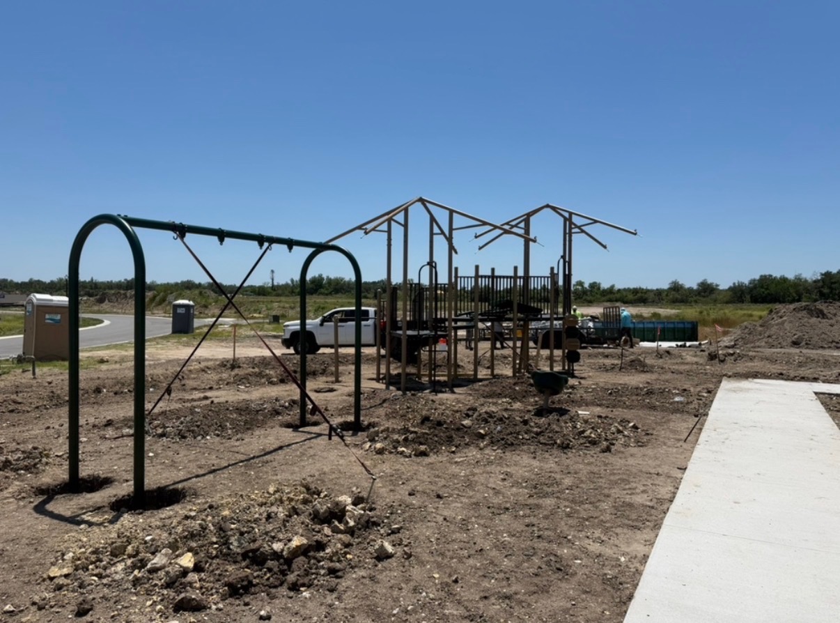Unfinished playground with swings and slides