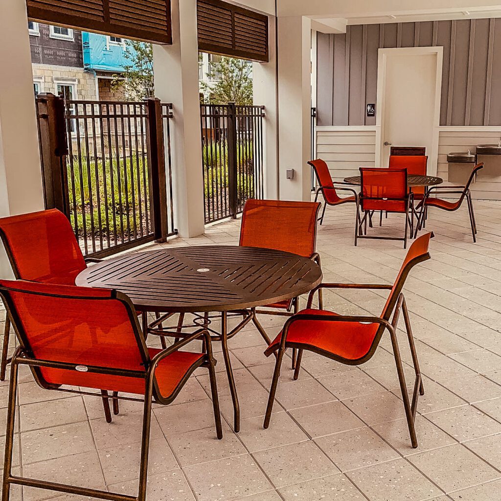 Outdoor patio with red chairs and tables