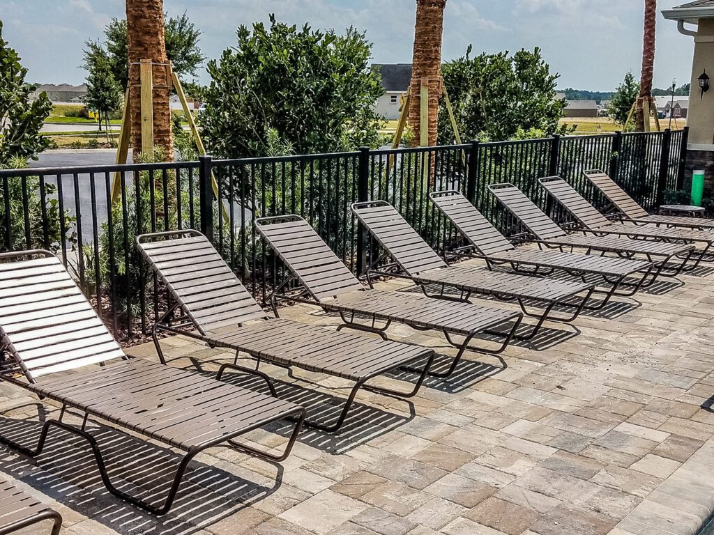 Empty sun loungers by the pool