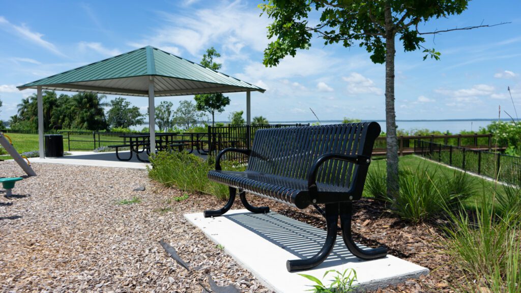 Outdoor seating by a lakeside pavilion