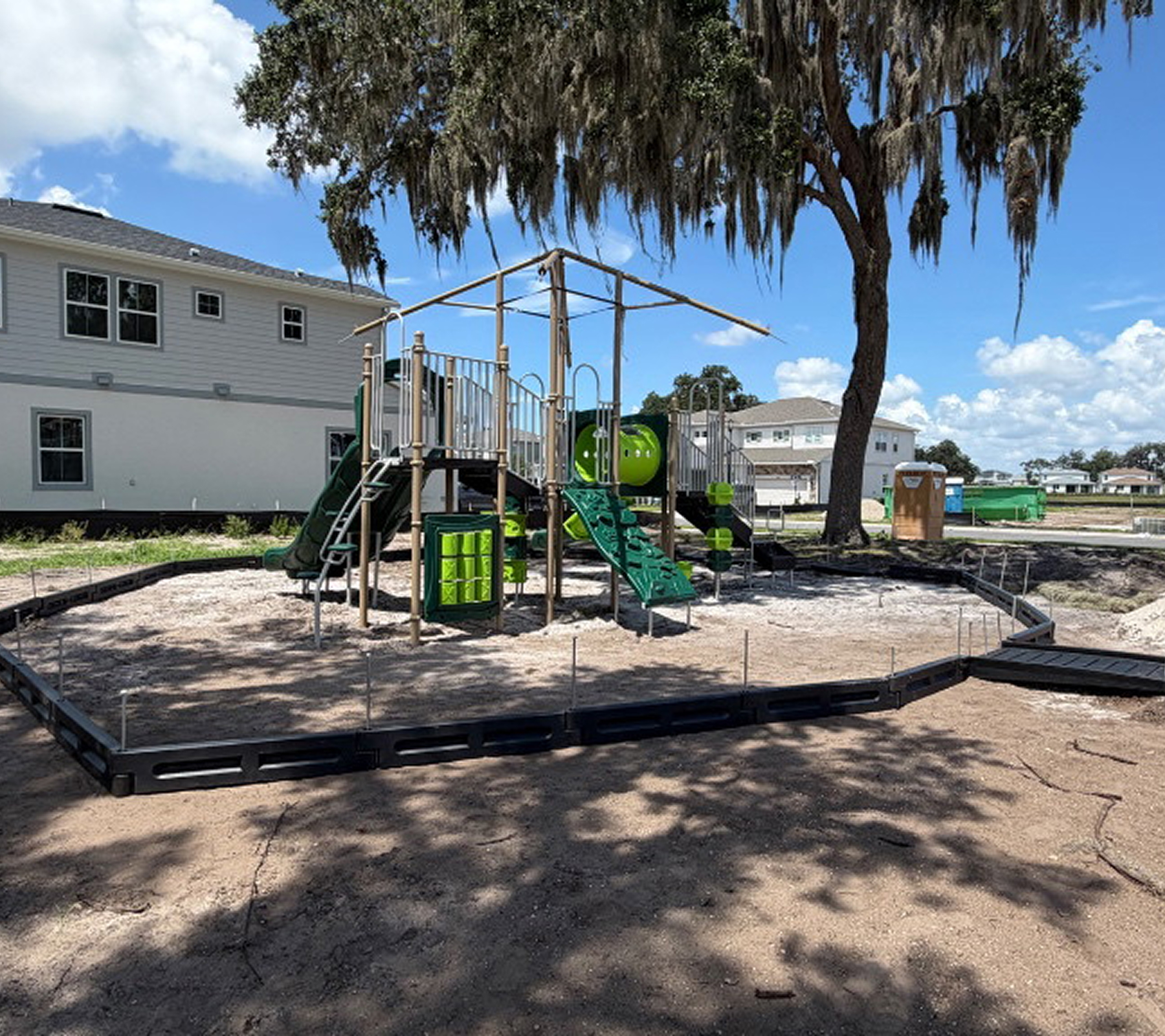 Playground with slide under a tree