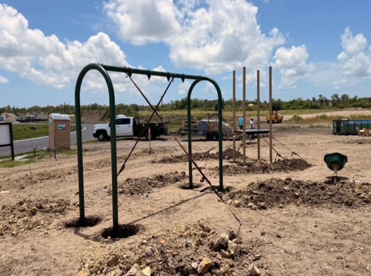 Playground under construction with swingset frame