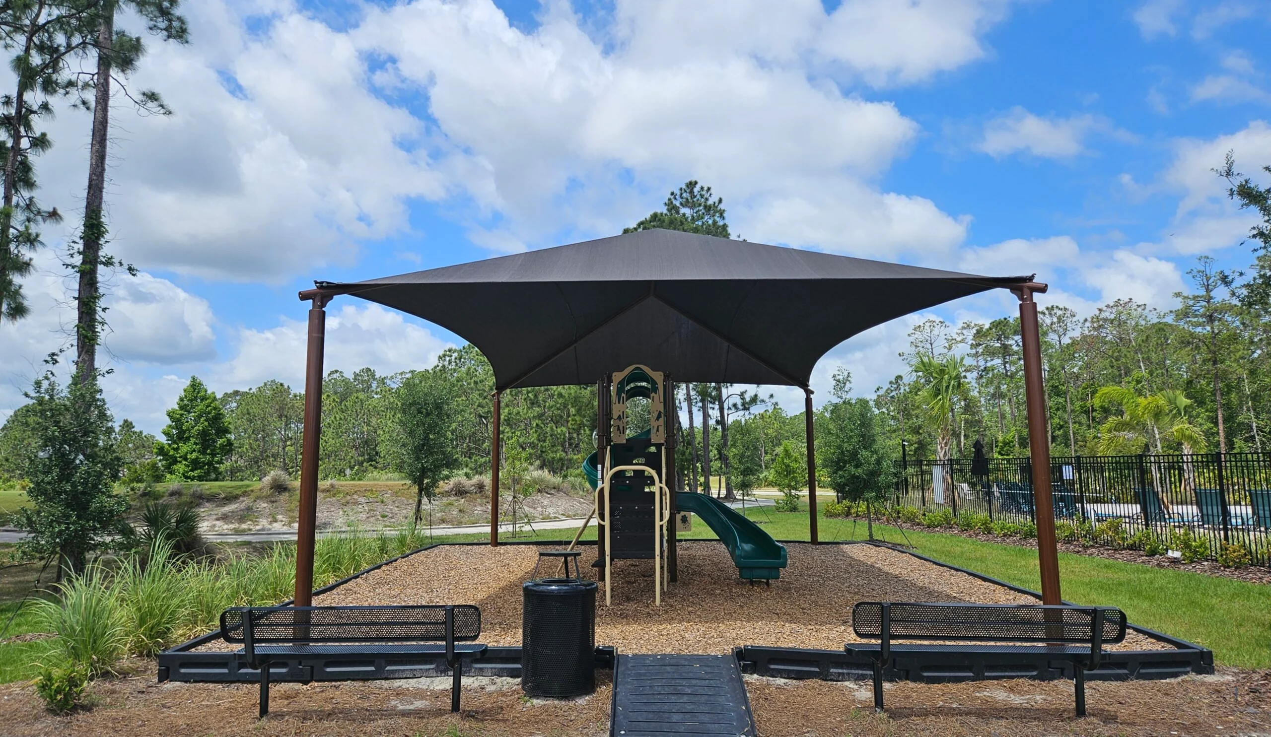 Playground with slide under sunshade canopy